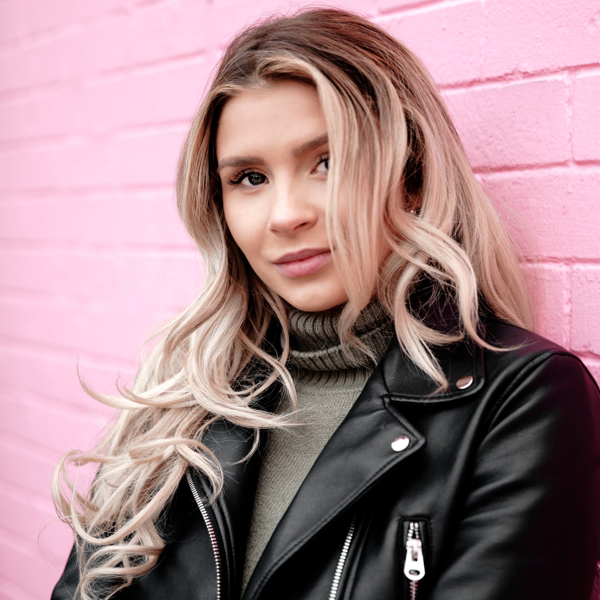 WOMAN PORTRAIT ON PINK BRICK 